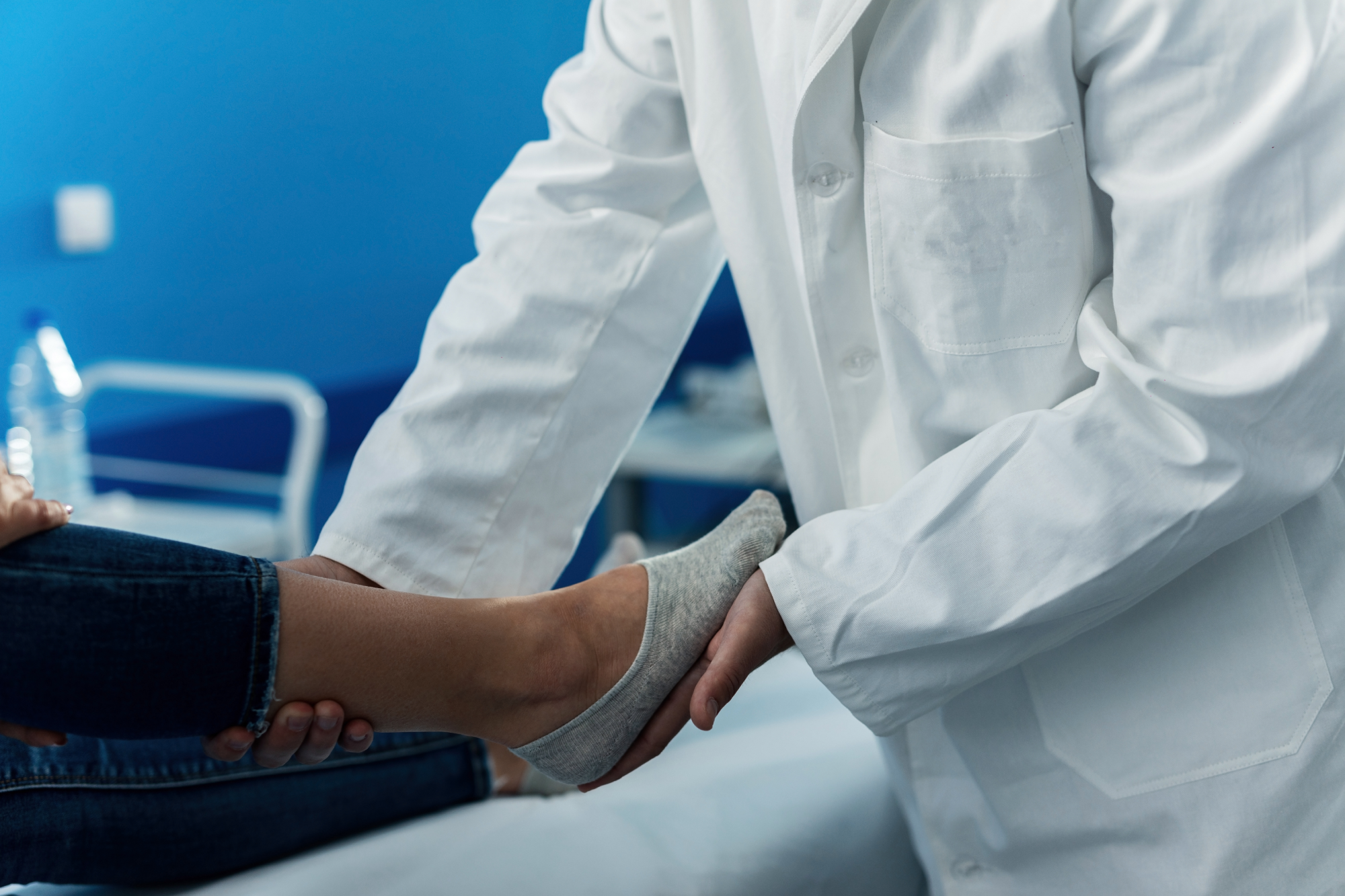 close-up-orthopedic-examining-foot-woman-doctor-s-office